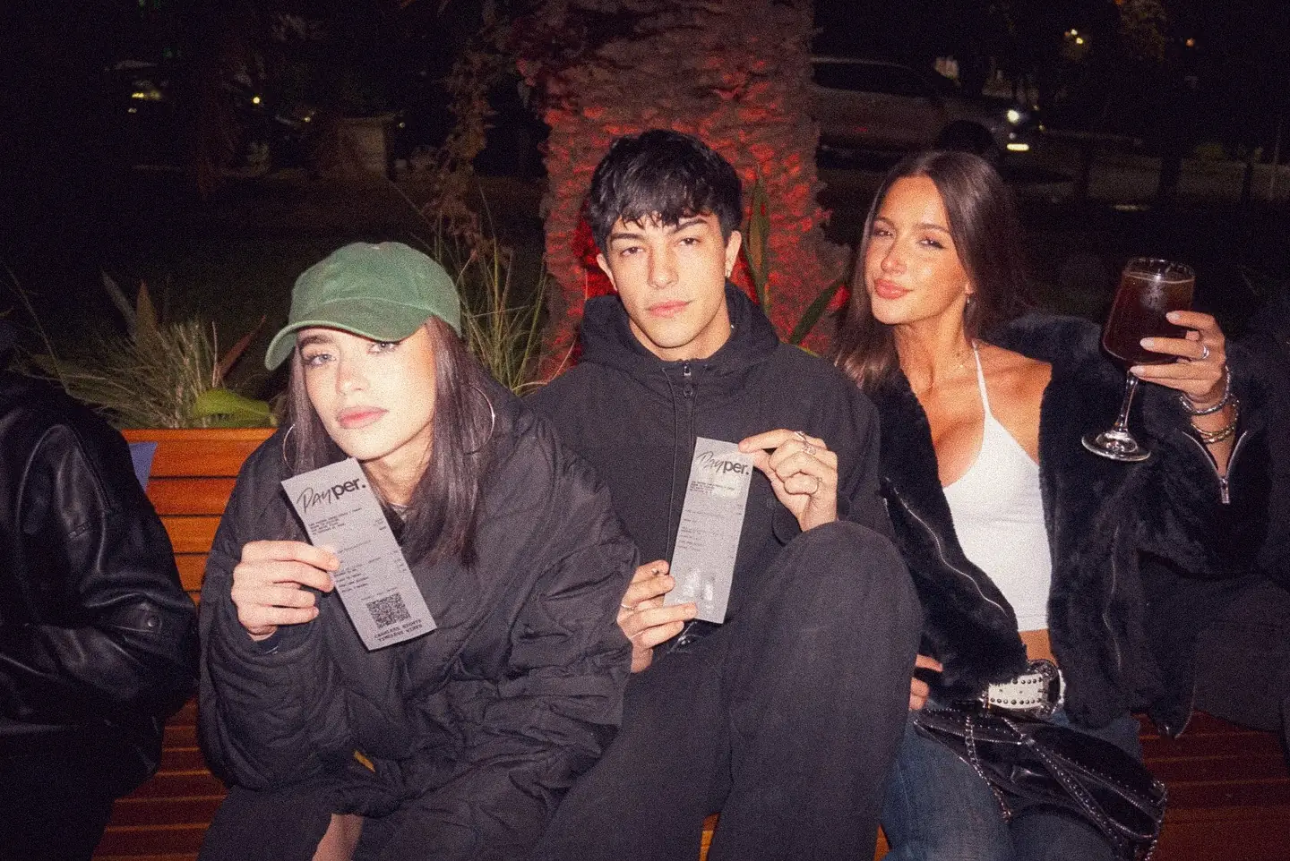 Three people on a night out holding their Payper tickets